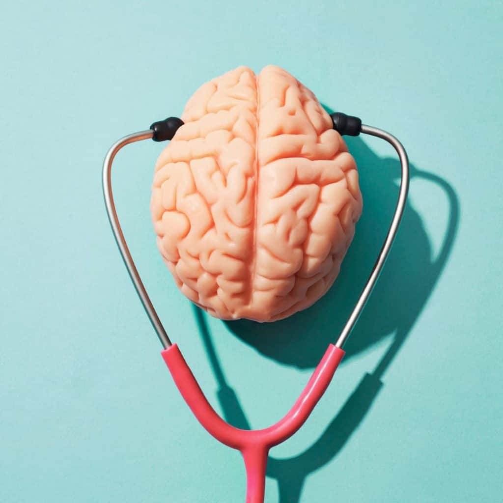 brain with stethoscope in front of blue background