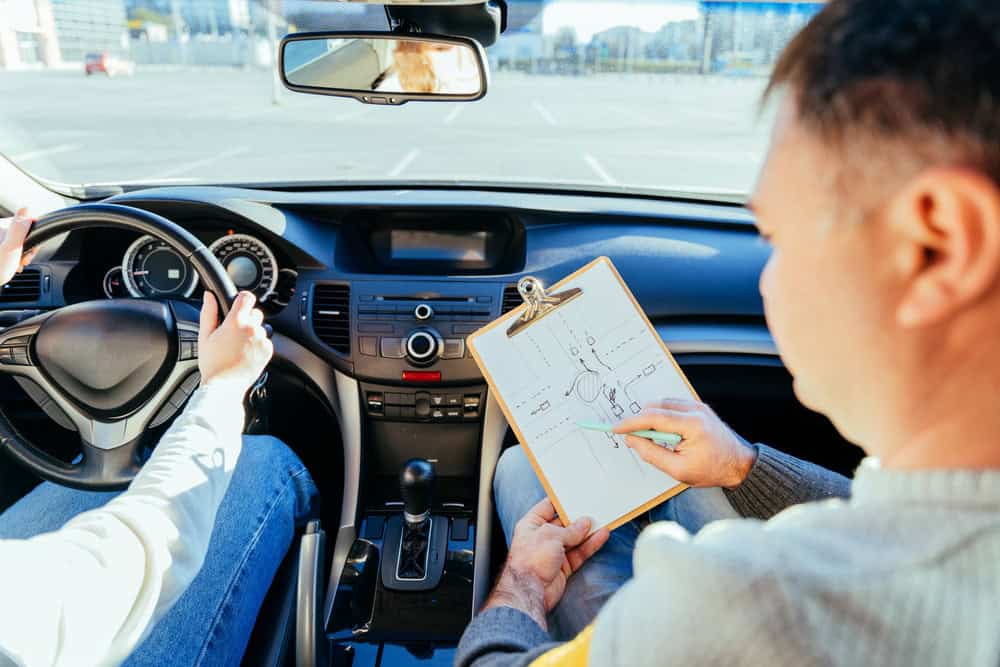 A driving assessor testing a student driver