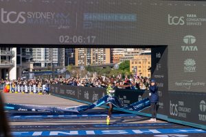 Finish line at the TCS Sydney Marathon with crowds gathered at Circular Quay.