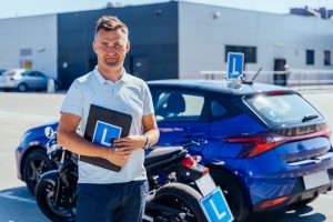 Driving instructor standing beside a learner car with L-plates in Melbourne