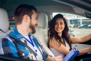 Driving instructor and learner driver smiling during a lesson in Melbourne