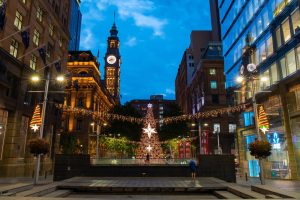 Sydney CBD at Christmas with festive lights and a large Christmas tree near Pitt Street Mall