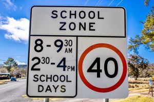 School zone sign highlighting restricted hours during school days near residential streets