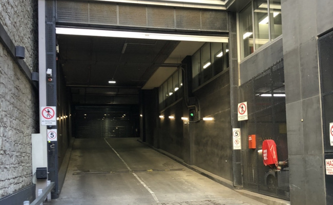 Secure undercover car space in Melbourne with storage cage