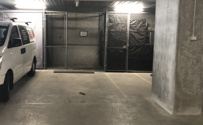 Secure undercover car space in Melbourne with storage cage