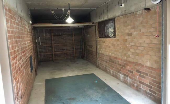 Lock up garage with auto lift door and rear door.